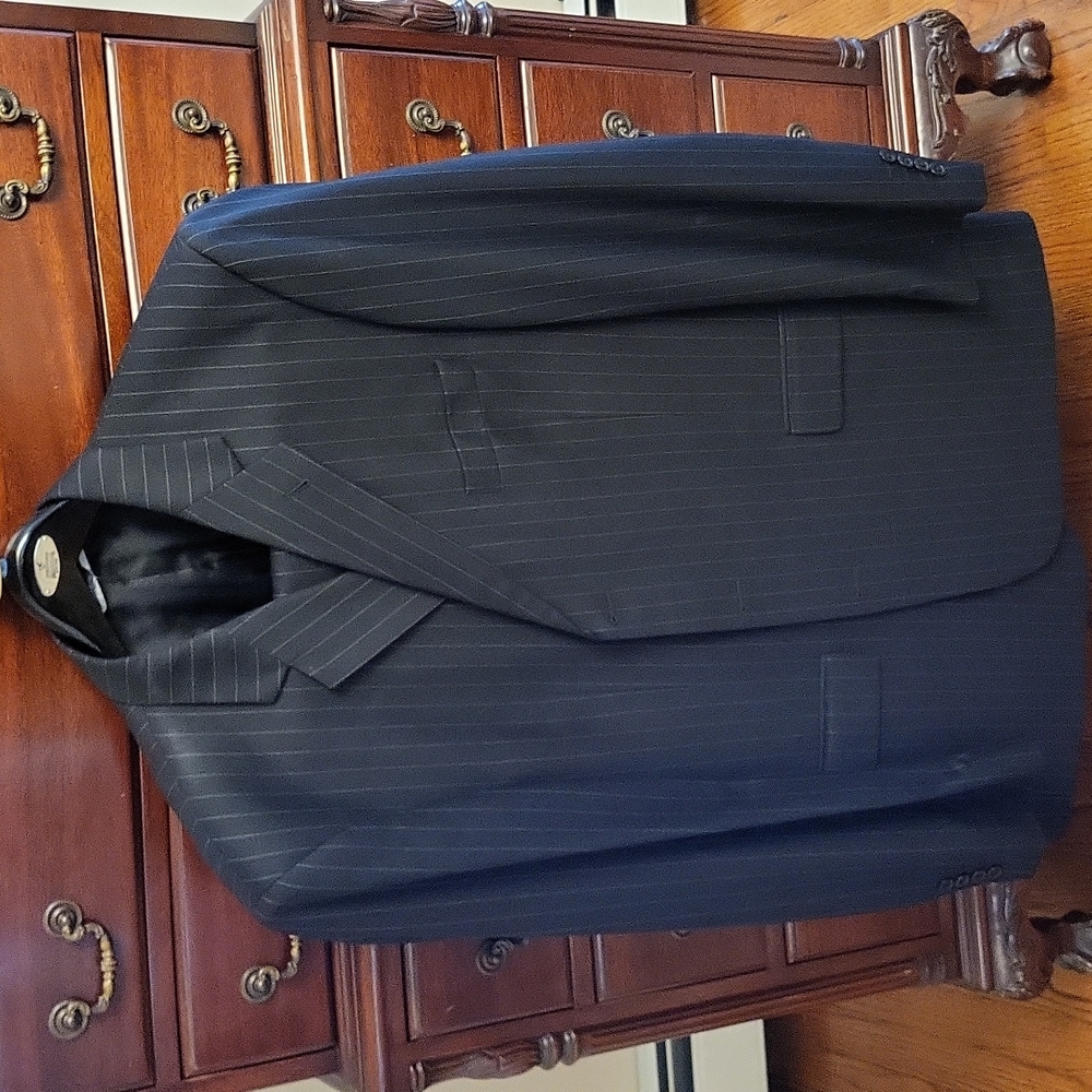 Mens 3 button mens wool suit by Stafford. Size 46long. Pants are pleated & cuffs